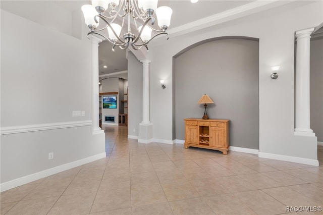 interior space with a notable chandelier, decorative columns, and light tile patterned floors