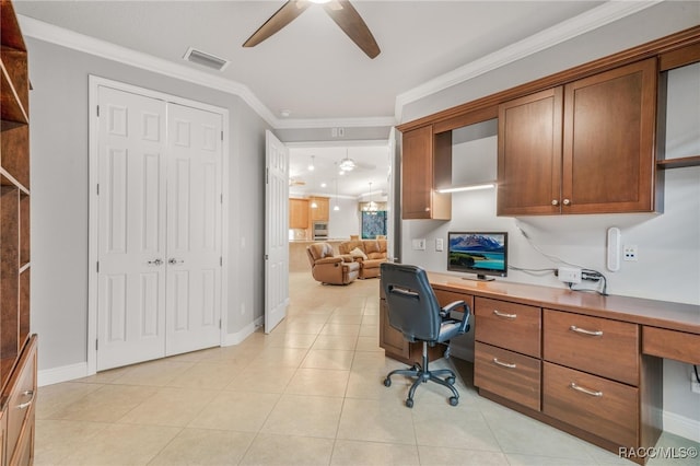 tiled office space with ceiling fan, built in desk, and crown molding