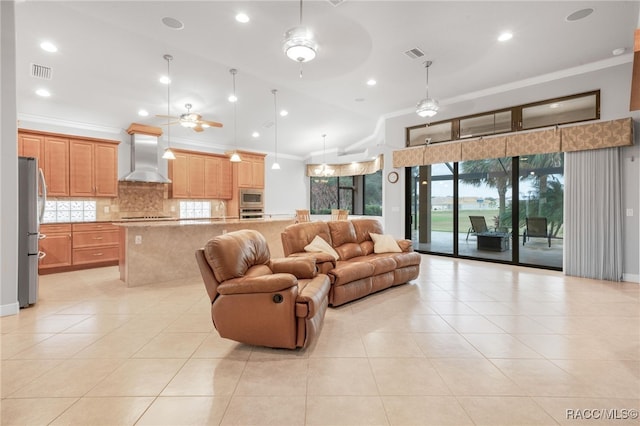 tiled living room with lofted ceiling, ornamental molding, and ceiling fan