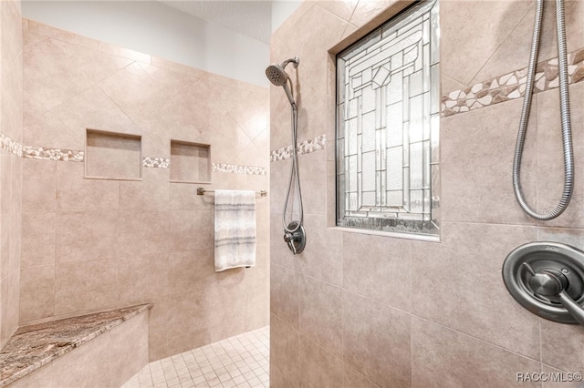 bathroom with a tile shower