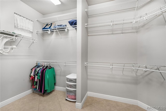 walk in closet with tile patterned flooring