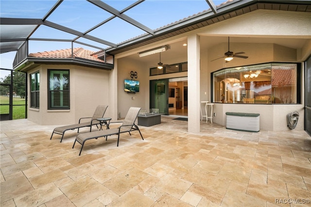 view of patio with ceiling fan and a lanai