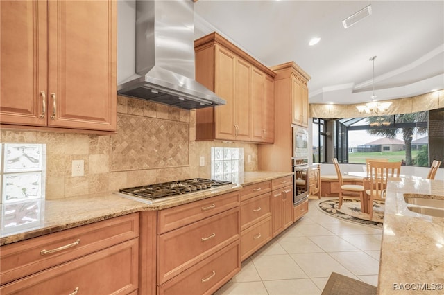 kitchen featuring stainless steel appliances, extractor fan, pendant lighting, and light stone countertops