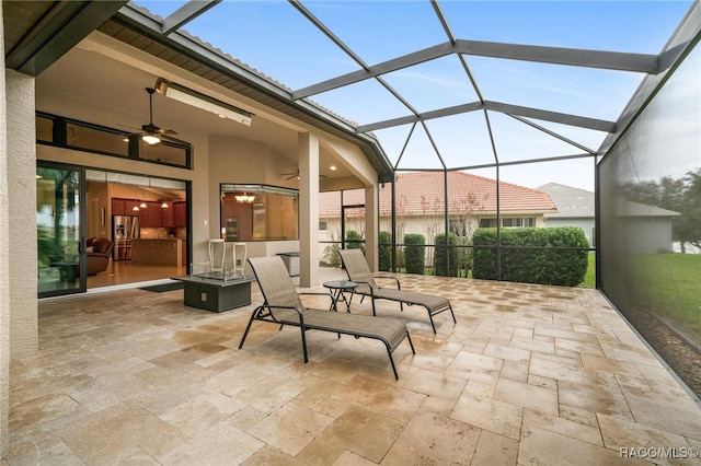 view of patio featuring a lanai and ceiling fan