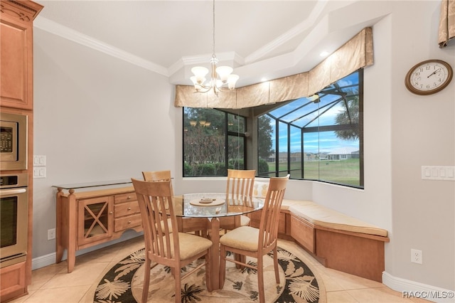 tiled dining room featuring an inviting chandelier and ornamental molding