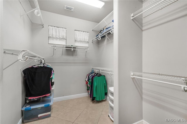 walk in closet featuring light tile patterned floors