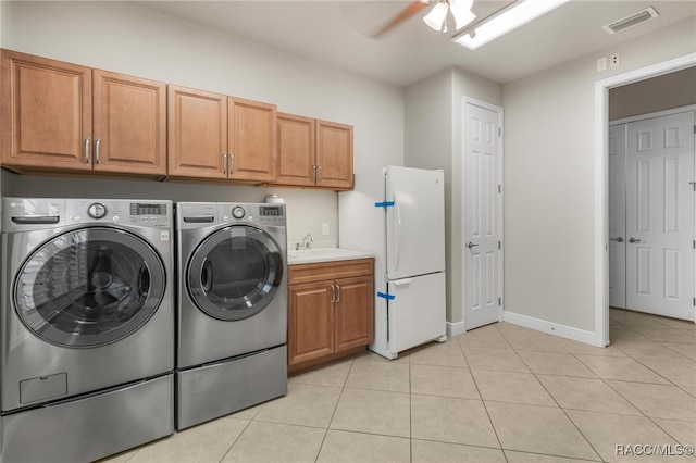 clothes washing area with light tile patterned floors, cabinets, separate washer and dryer, ceiling fan, and sink