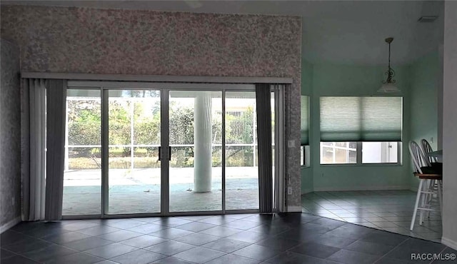 doorway to outside featuring tile patterned flooring, baseboards, and french doors