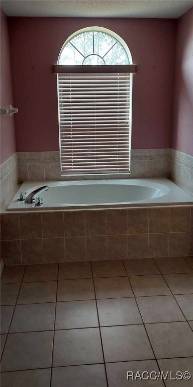 bathroom featuring a bath and tile patterned flooring