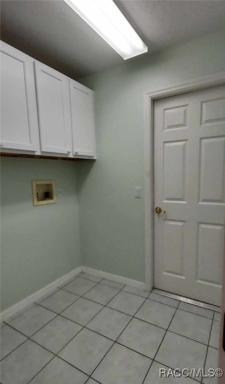 laundry room with cabinet space, washer hookup, baseboards, and light tile patterned floors