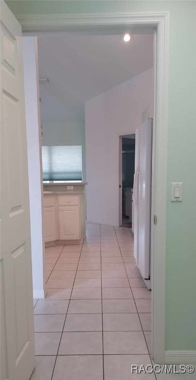 hall featuring light tile patterned floors