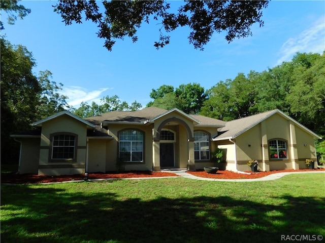 ranch-style home with a front yard