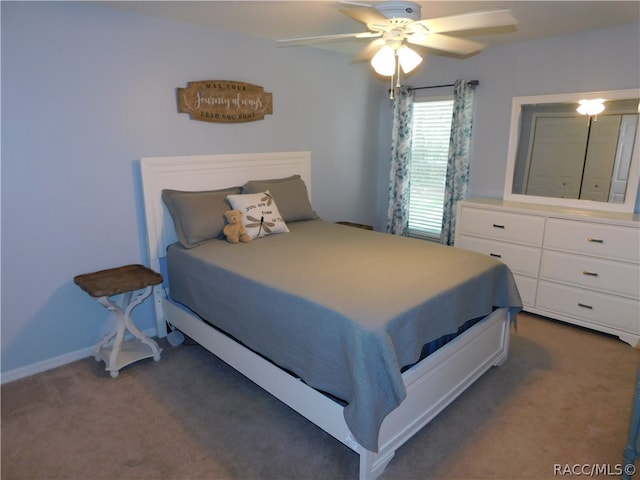 bedroom featuring ceiling fan and dark carpet