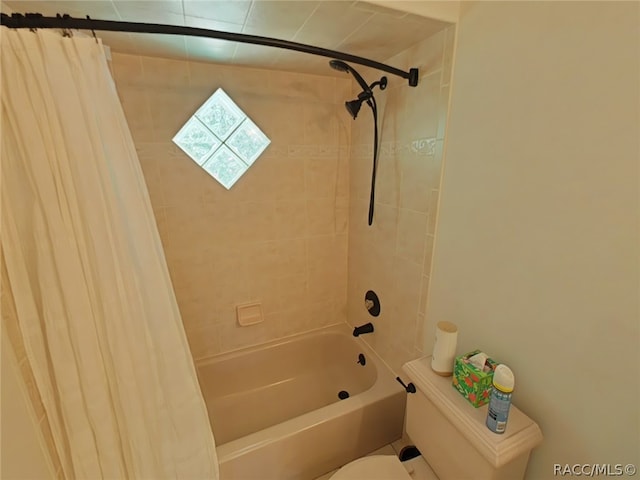 bathroom with toilet and shower / tub combo with curtain