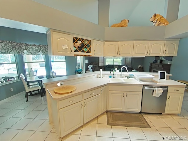 kitchen featuring high vaulted ceiling, sink, stainless steel dishwasher, light tile patterned flooring, and kitchen peninsula