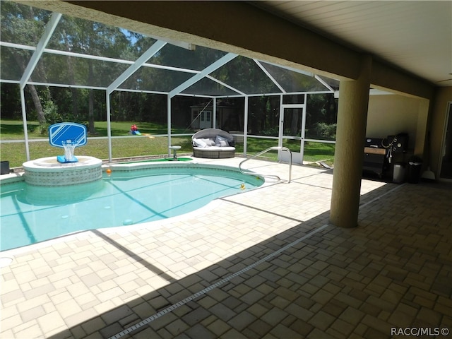 view of swimming pool featuring a patio, glass enclosure, and a lawn