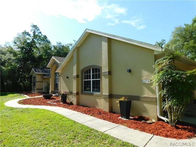 view of side of home featuring a yard