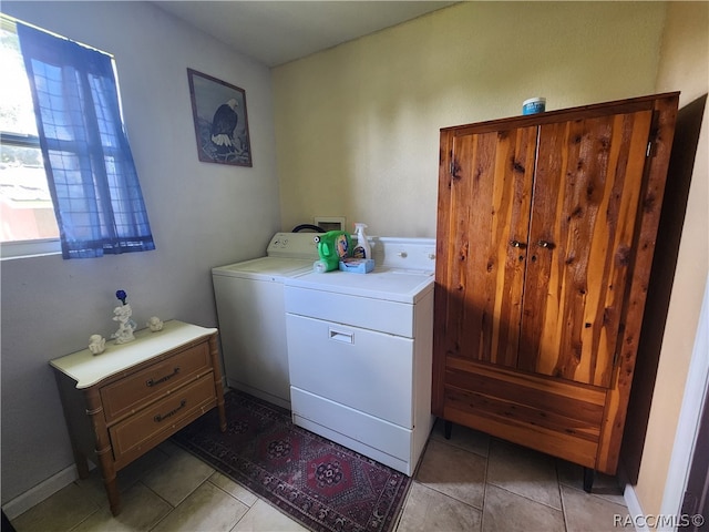 washroom featuring washing machine and dryer and light tile patterned floors