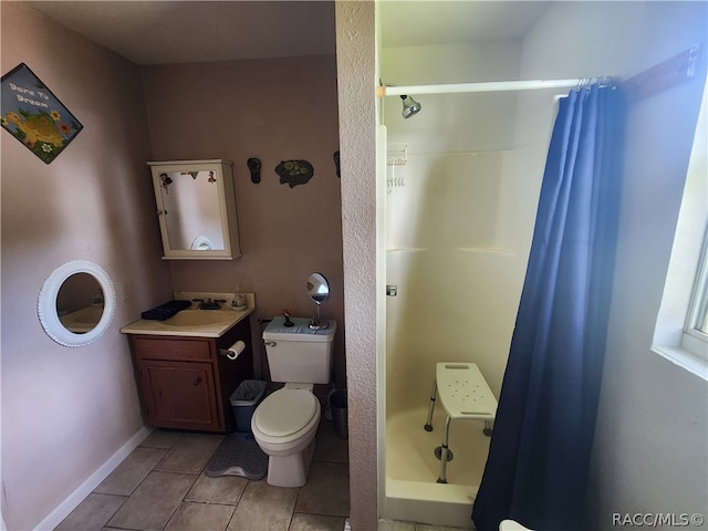 bathroom with tile patterned floors, toilet, vanity, and a shower with shower curtain