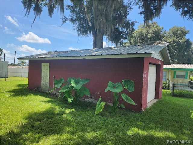 view of outdoor structure featuring a yard and a garage