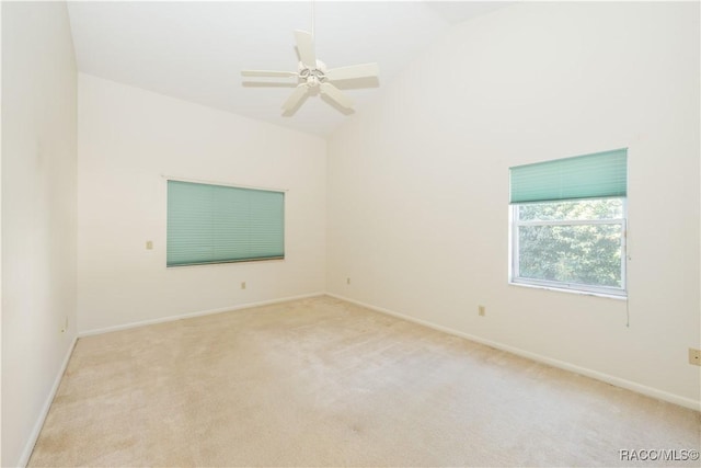 unfurnished room with high vaulted ceiling, light carpet, and ceiling fan