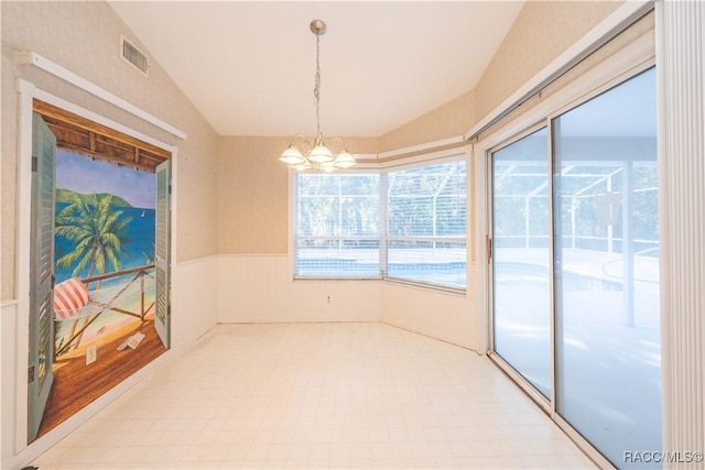 unfurnished dining area with an inviting chandelier