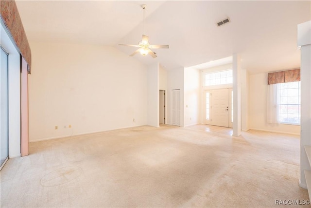 empty room featuring ceiling fan, light colored carpet, and high vaulted ceiling