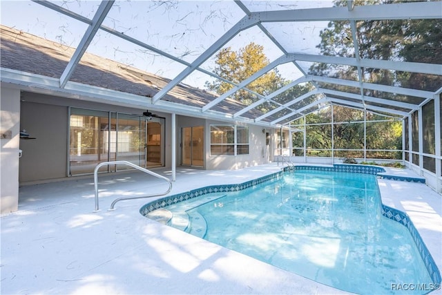 view of swimming pool featuring a patio, a lanai, and ceiling fan