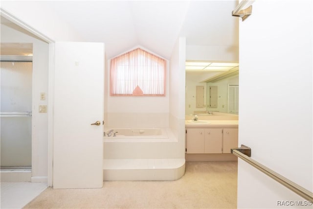 bathroom featuring vanity and a washtub