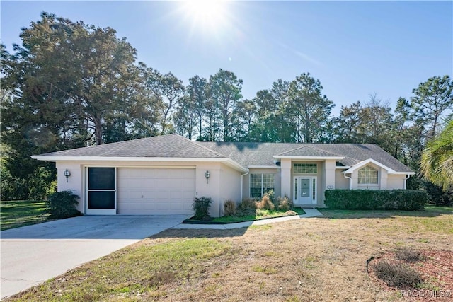 ranch-style house with a garage and a front lawn