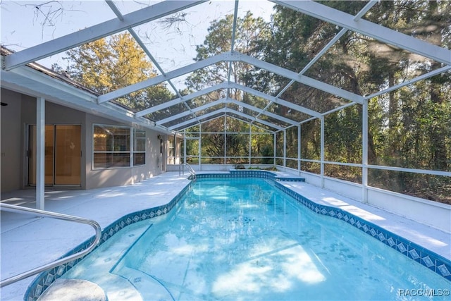 view of swimming pool featuring a lanai and a patio area