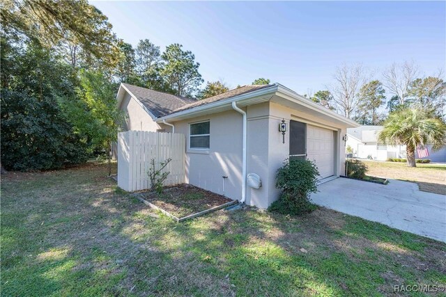 view of home's exterior featuring a garage and a yard