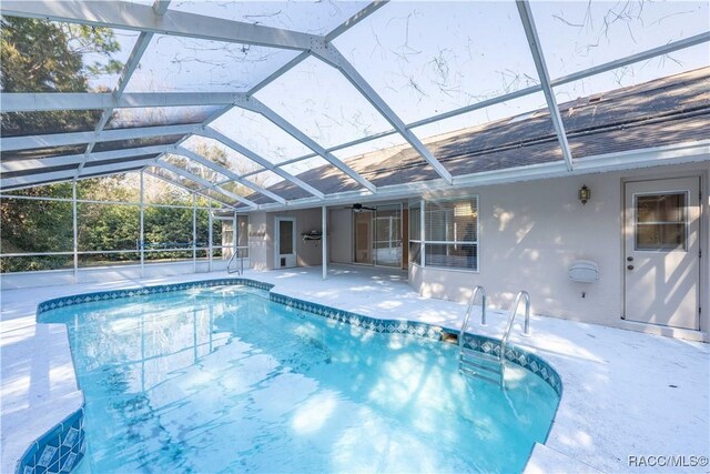 view of pool featuring a lanai and a patio