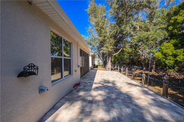 view of side of property featuring a patio area