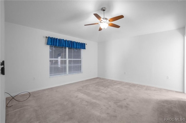 empty room with ceiling fan and carpet