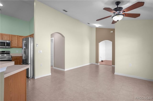 kitchen with stainless steel appliances, ceiling fan, and light tile patterned flooring