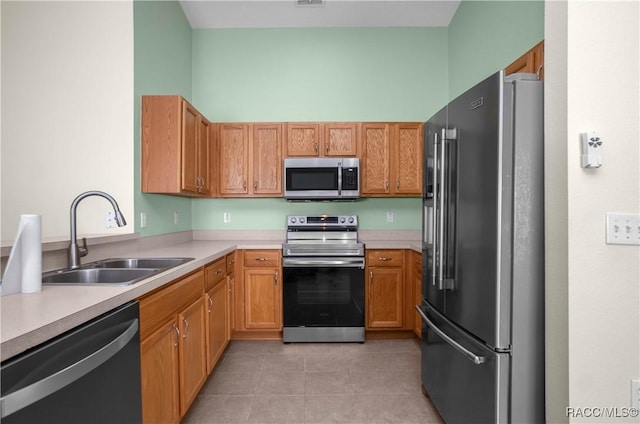 kitchen featuring light tile patterned floors, sink, and appliances with stainless steel finishes