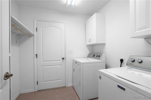 washroom featuring light tile patterned flooring, cabinets, and independent washer and dryer