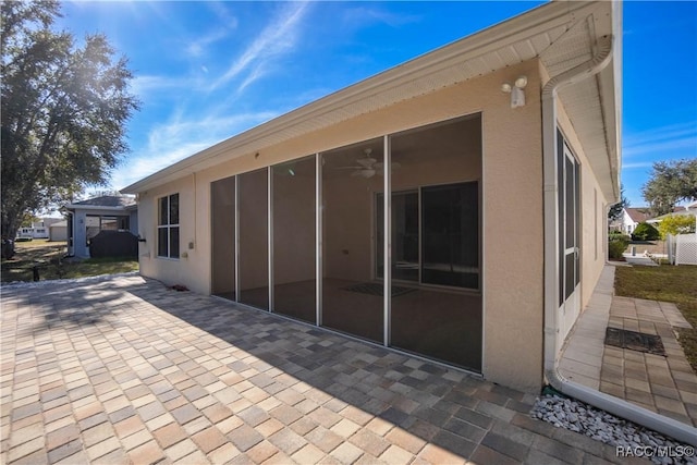 exterior space with ceiling fan