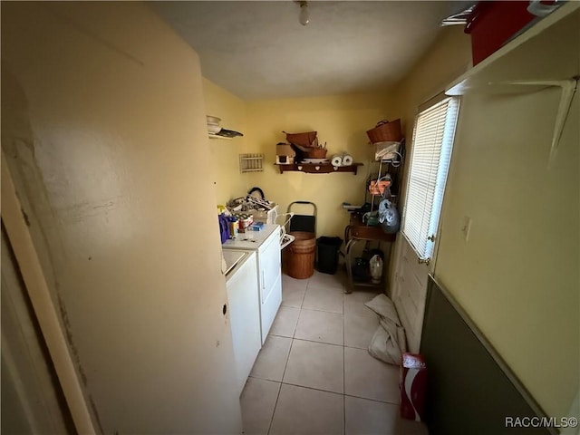 laundry area featuring separate washer and dryer and light tile patterned flooring