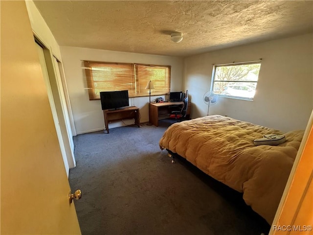 bedroom with carpet floors and a textured ceiling