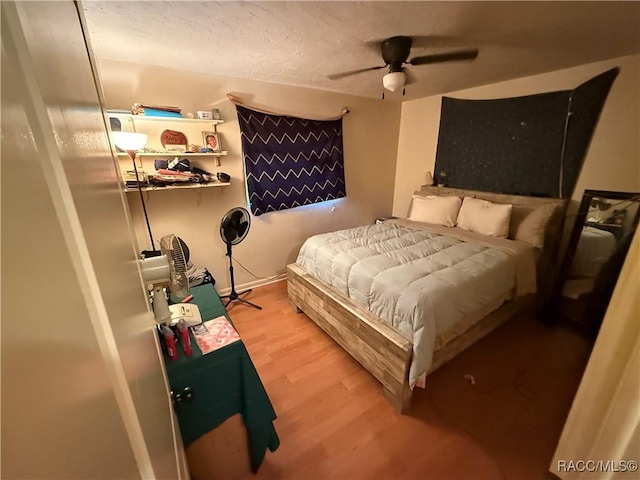 bedroom featuring hardwood / wood-style flooring and ceiling fan