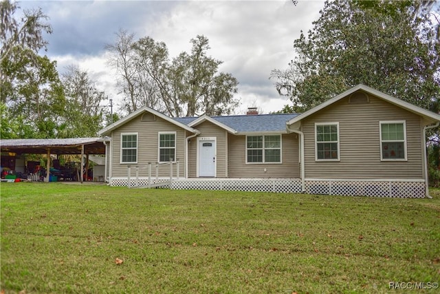 ranch-style house featuring a carport and a front lawn