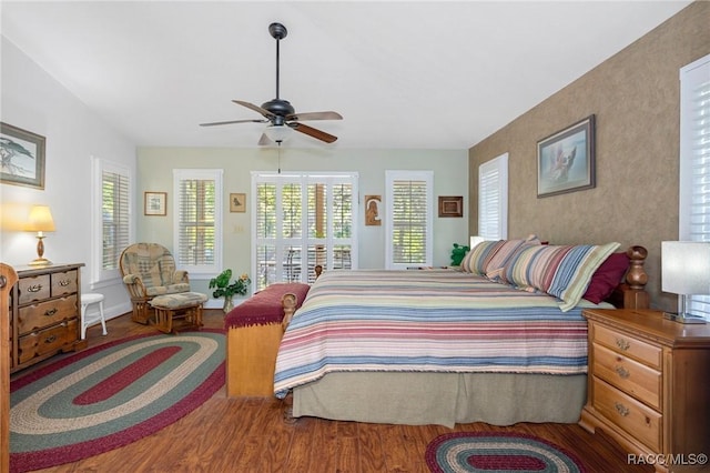 bedroom featuring multiple windows, ceiling fan, and wood-type flooring