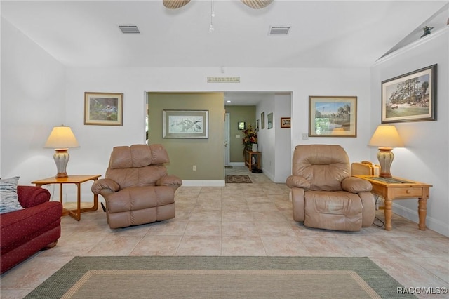 living room with ceiling fan, light tile patterned flooring, and lofted ceiling