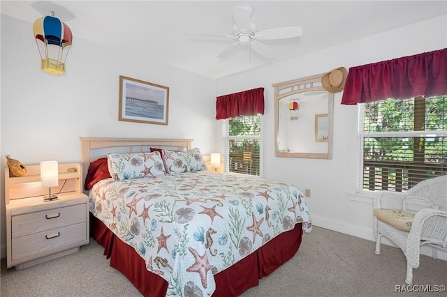 carpeted bedroom with ceiling fan and baseboards