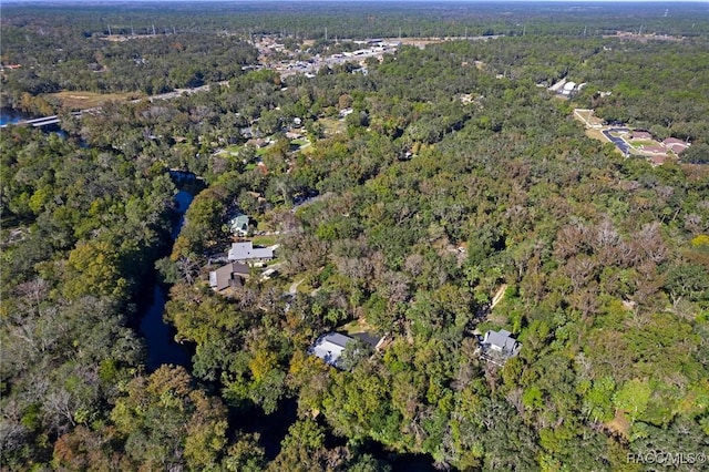 birds eye view of property with a wooded view