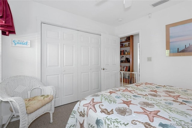 carpeted bedroom featuring a ceiling fan, a closet, and visible vents