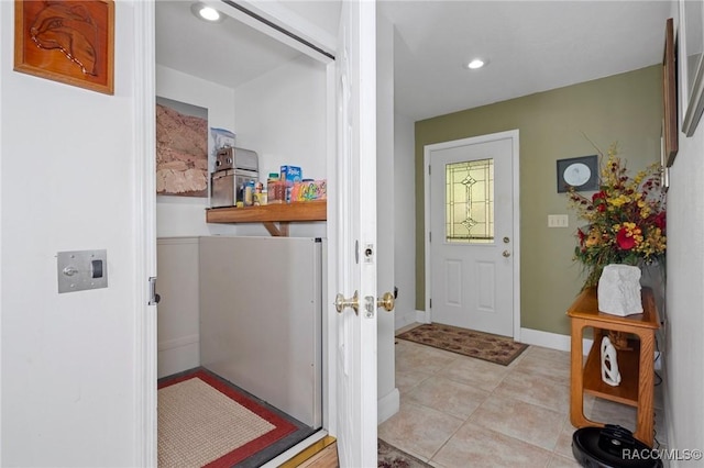 entryway with light tile patterned floors, baseboards, and recessed lighting