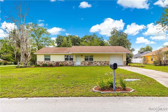 4325 NE 33rd Ave, Ocala, FL 34479 - ranch-style house featuring stone siding, an attached garage, concrete driveway, and a front yard